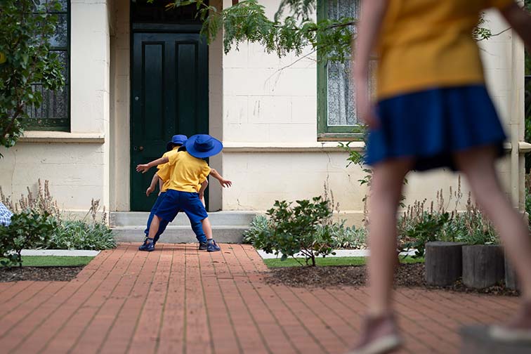 Group of kids playing tunnel ball outside