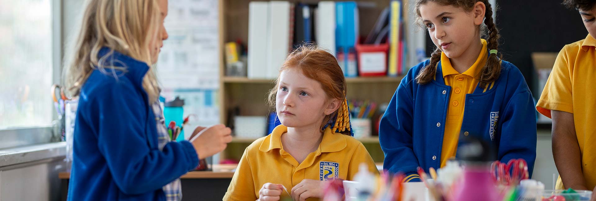 students listening to a blonde girl